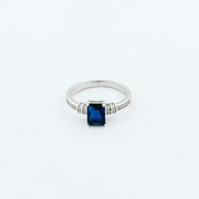 A beautifully crafted silver ring featuring a stunning sapphire gemstone and diamond accents.